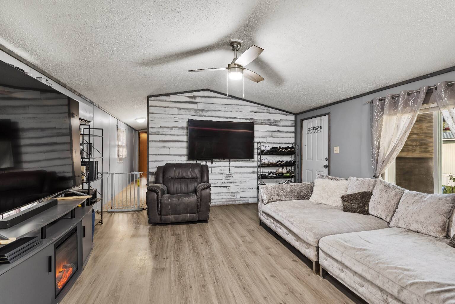 Polished finished room with white and gray wood plank accent wall