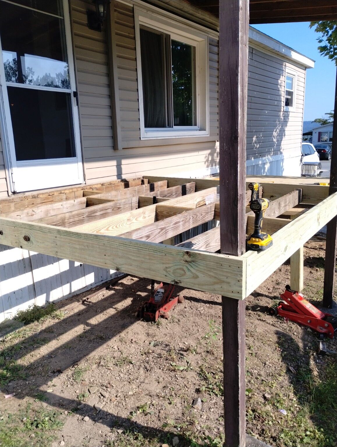 New pressure-treated deck framing under construction