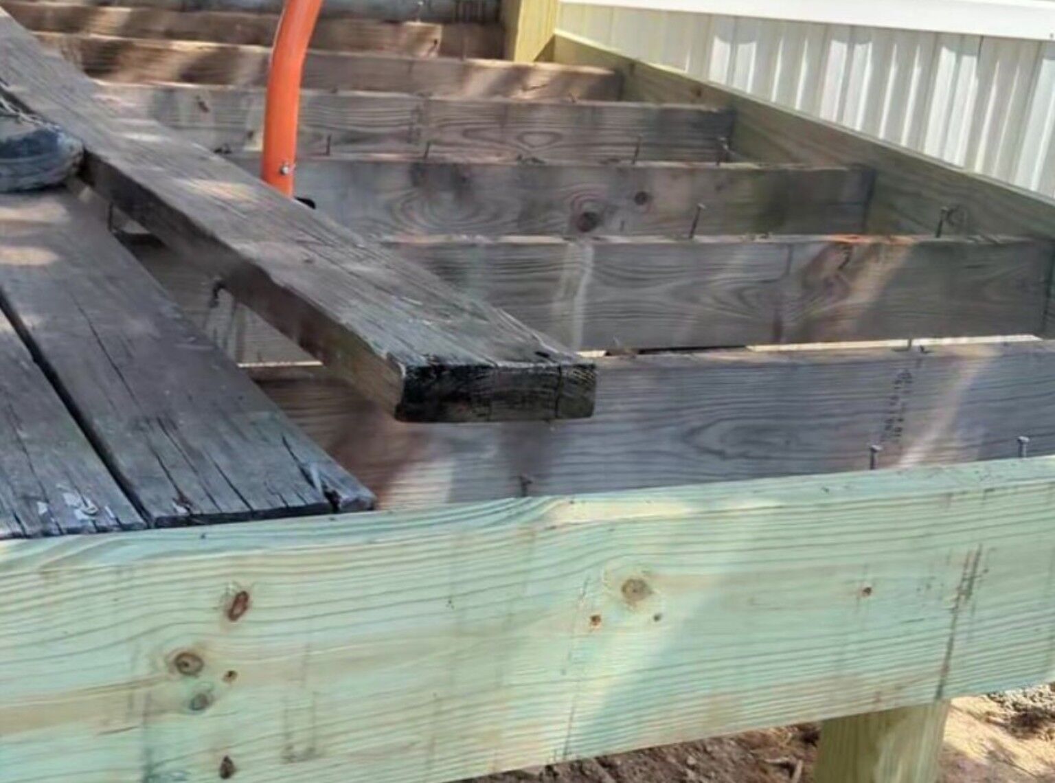 Damaged old deck boards removed over repaired framing