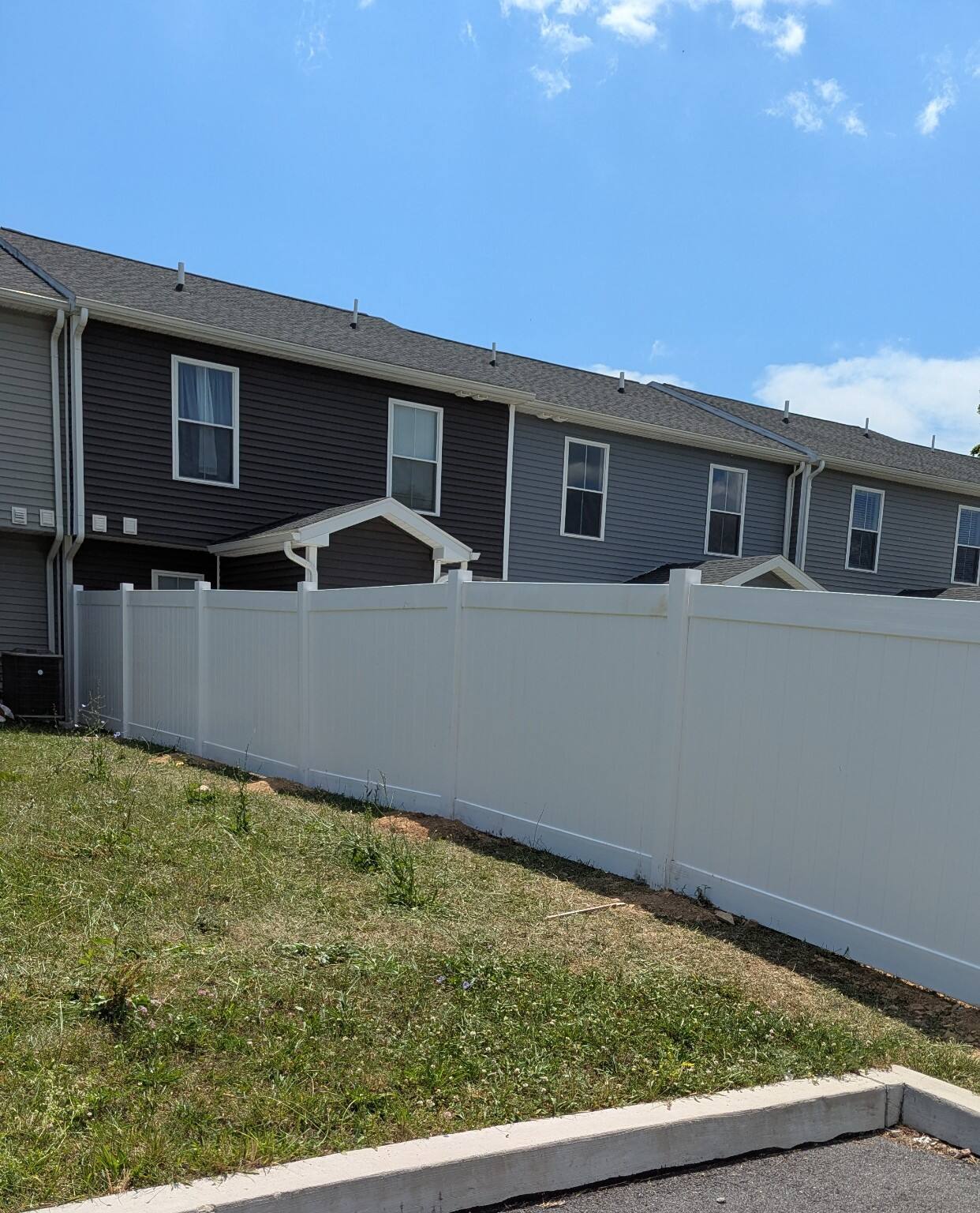 Completed Pitboss white vinyl privacy fence