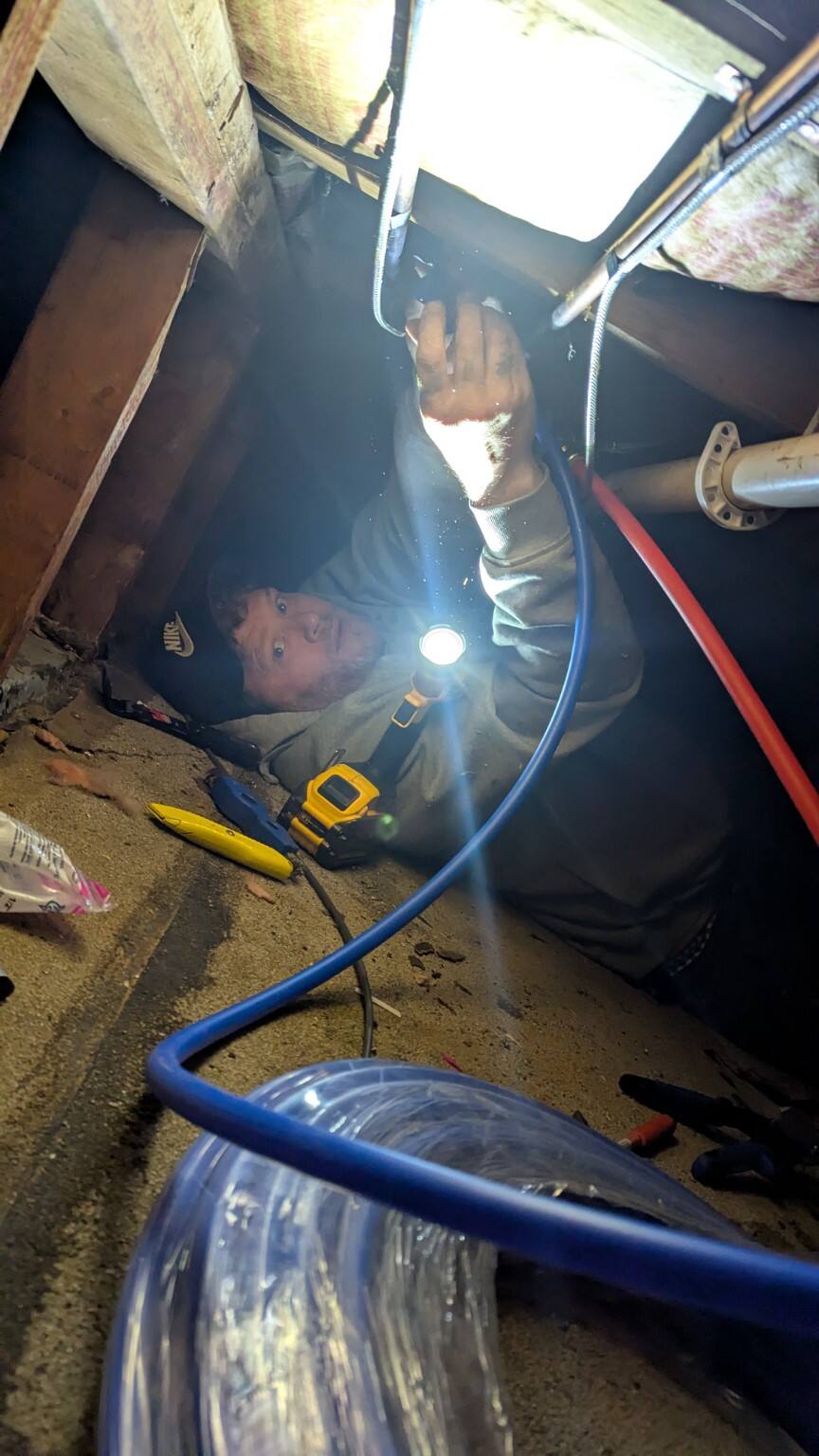 Pitboss working in a tight crawl space