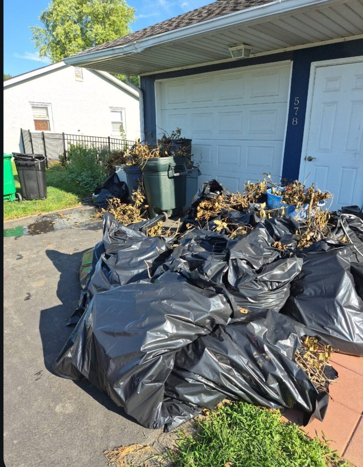 Bagged yard waste and outdoor debris ready for removal